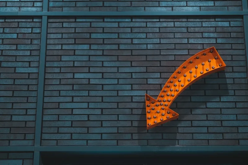 Illuminated business signage on building wall